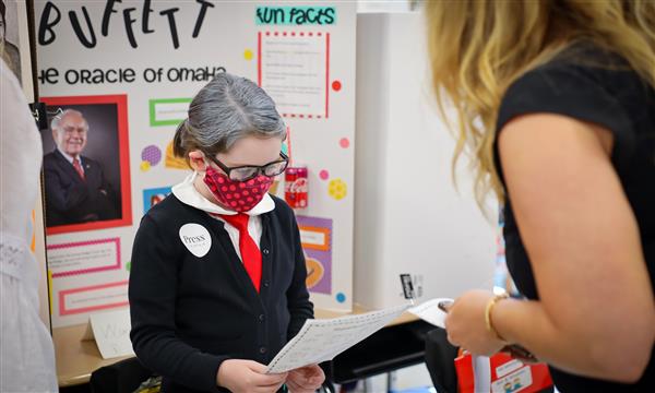 Student shares project with teacher